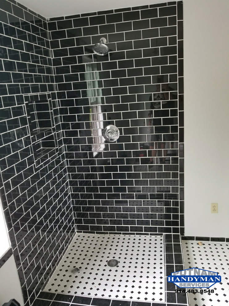 Design ideas for a medium sized modern ensuite bathroom in New York with a corner shower, a one-piece toilet, black tiles, cement tiles, white walls, ceramic flooring, white floors and a hinged door.