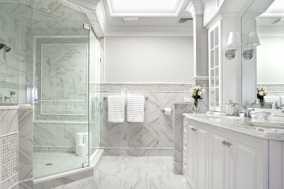 Design ideas for a contemporary ensuite bathroom in New York with a built-in sink, recessed-panel cabinets, white cabinets, a corner shower, a one-piece toilet, white walls and porcelain flooring.