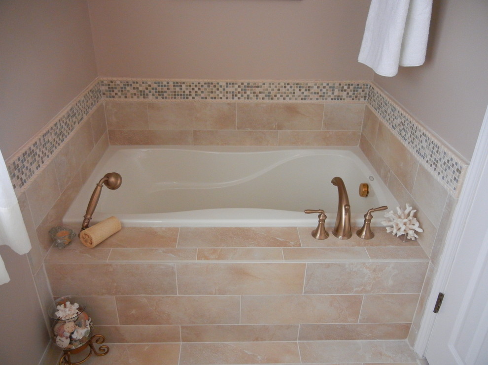 Immagine di una stanza da bagno chic con piastrelle beige e doccia alcova