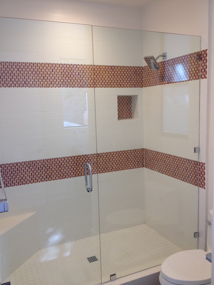 Inspiration for a mid-sized modern 3/4 brown tile, white tile and mosaic tile alcove shower remodel in San Diego with a two-piece toilet, white walls and a hinged shower door