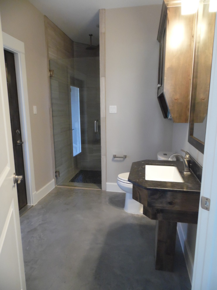 Example of a mid-sized classic kids' concrete floor walk-in shower design in Austin with a drop-in sink, recessed-panel cabinets, light wood cabinets, granite countertops, a one-piece toilet and beige walls