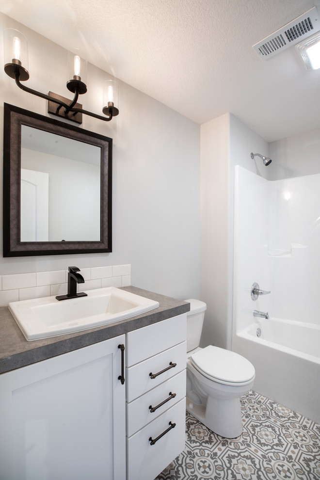 На фото: ванная комната в современном стиле с фасадами с утопленной филенкой, белыми фасадами, накладной ванной, душем над ванной, унитазом-моноблоком, белой плиткой, керамической плиткой, коричневыми стенами, полом из керамической плитки, столешницей из ламината, разноцветным полом, шторкой для ванной и коричневой столешницей с