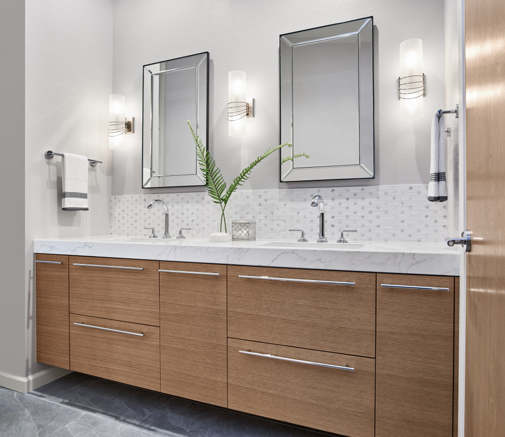 Photo of a contemporary ensuite bathroom in San Francisco with flat-panel cabinets, light wood cabinets, an alcove shower, white tiles, marble tiles, solid surface worktops, a hinged door and white worktops.
