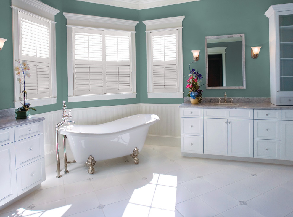 This is an example of an expansive victorian ensuite half tiled bathroom in Other with shaker cabinets, white cabinets, a claw-foot bath, green walls, ceramic flooring, a submerged sink, marble worktops and white floors.