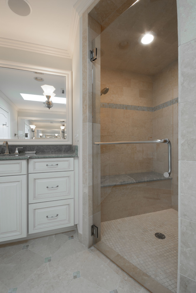 Example of a large classic master beige tile and ceramic tile porcelain tile walk-in shower design in Detroit with an undermount sink, recessed-panel cabinets, white cabinets, granite countertops, a one-piece toilet and white walls