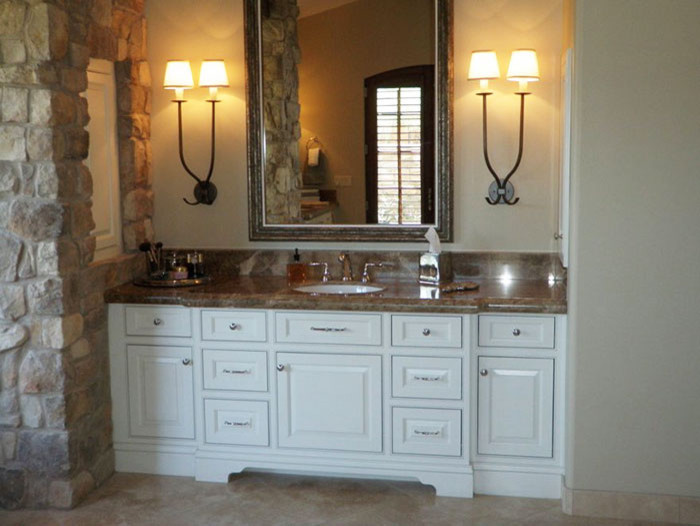 Inspiration for a huge timeless master marble floor corner bathtub remodel in Grand Rapids with raised-panel cabinets, white cabinets, beige walls, an undermount sink and granite countertops
