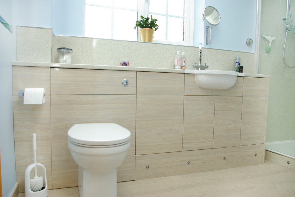 Example of a trendy bathroom design in Other with flat-panel cabinets and a drop-in sink