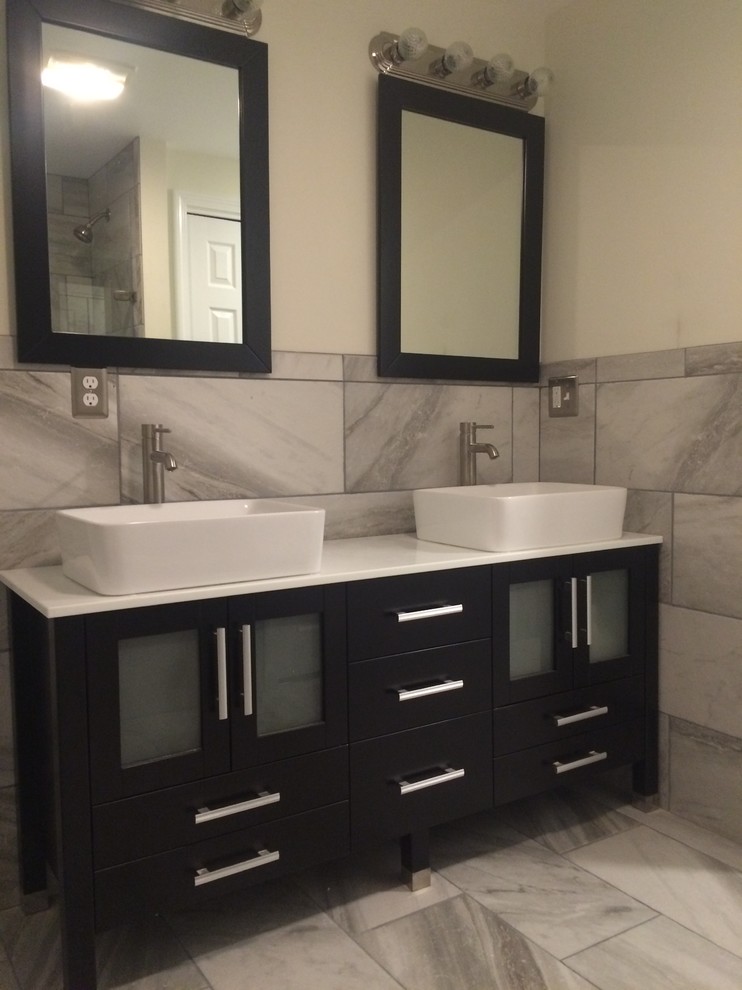 Photo of a medium sized modern ensuite bathroom in Other with glass-front cabinets, dark wood cabinets and a vessel sink.