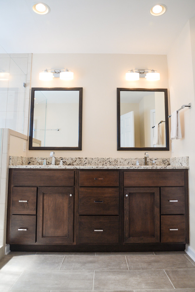 Mid-sized transitional master beige tile and pebble tile porcelain tile corner shower photo in Raleigh with an undermount sink, shaker cabinets, medium tone wood cabinets, granite countertops, a two-piece toilet and beige walls