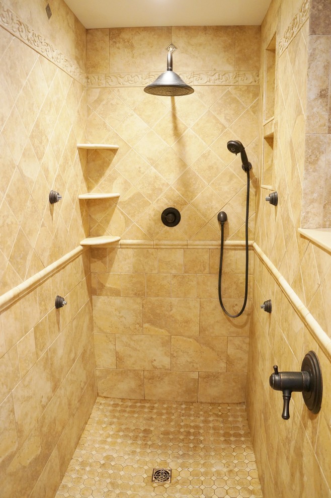 Inspiration for a mid-sized timeless master ceramic tile doorless shower remodel in Burlington with beige walls