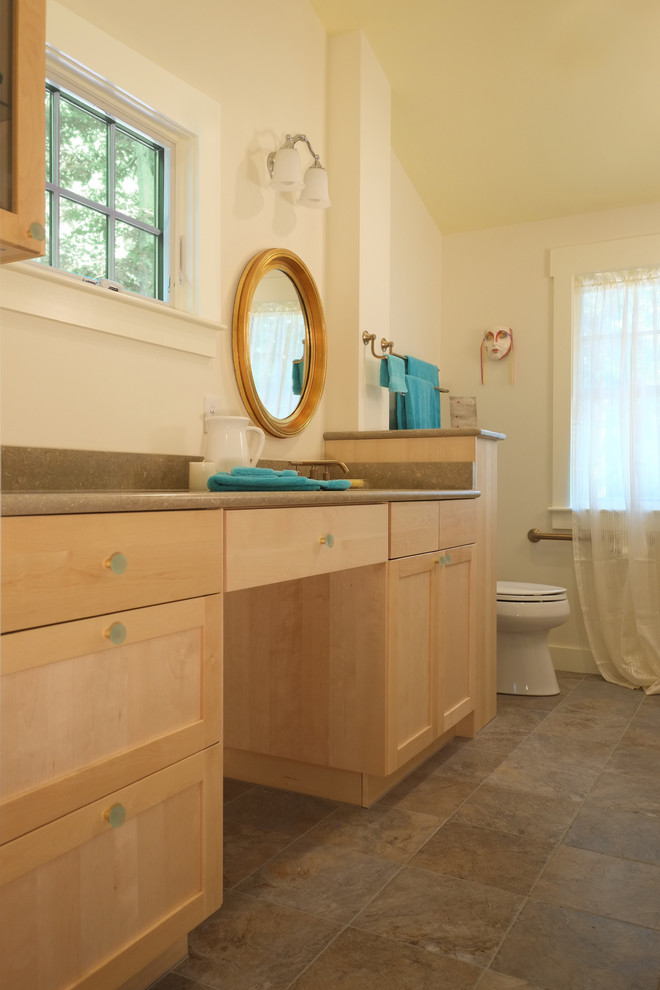 This is an example of a large traditional ensuite bathroom in Boston with shaker cabinets, light wood cabinets, a two-piece toilet, yellow walls, a built-in sink, brown tiles, ceramic flooring and laminate worktops.