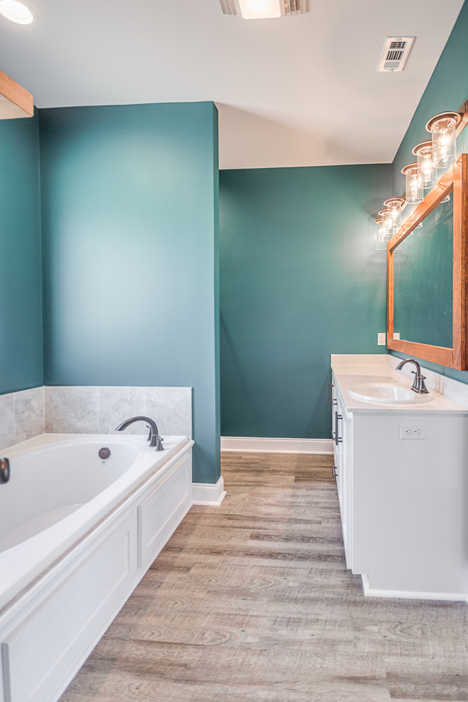 Design ideas for a medium sized classic ensuite bathroom in New Orleans with shaker cabinets, white cabinets, a built-in bath, an alcove shower, white tiles, ceramic tiles, green walls, vinyl flooring, marble worktops, grey floors, a hinged door and white worktops.