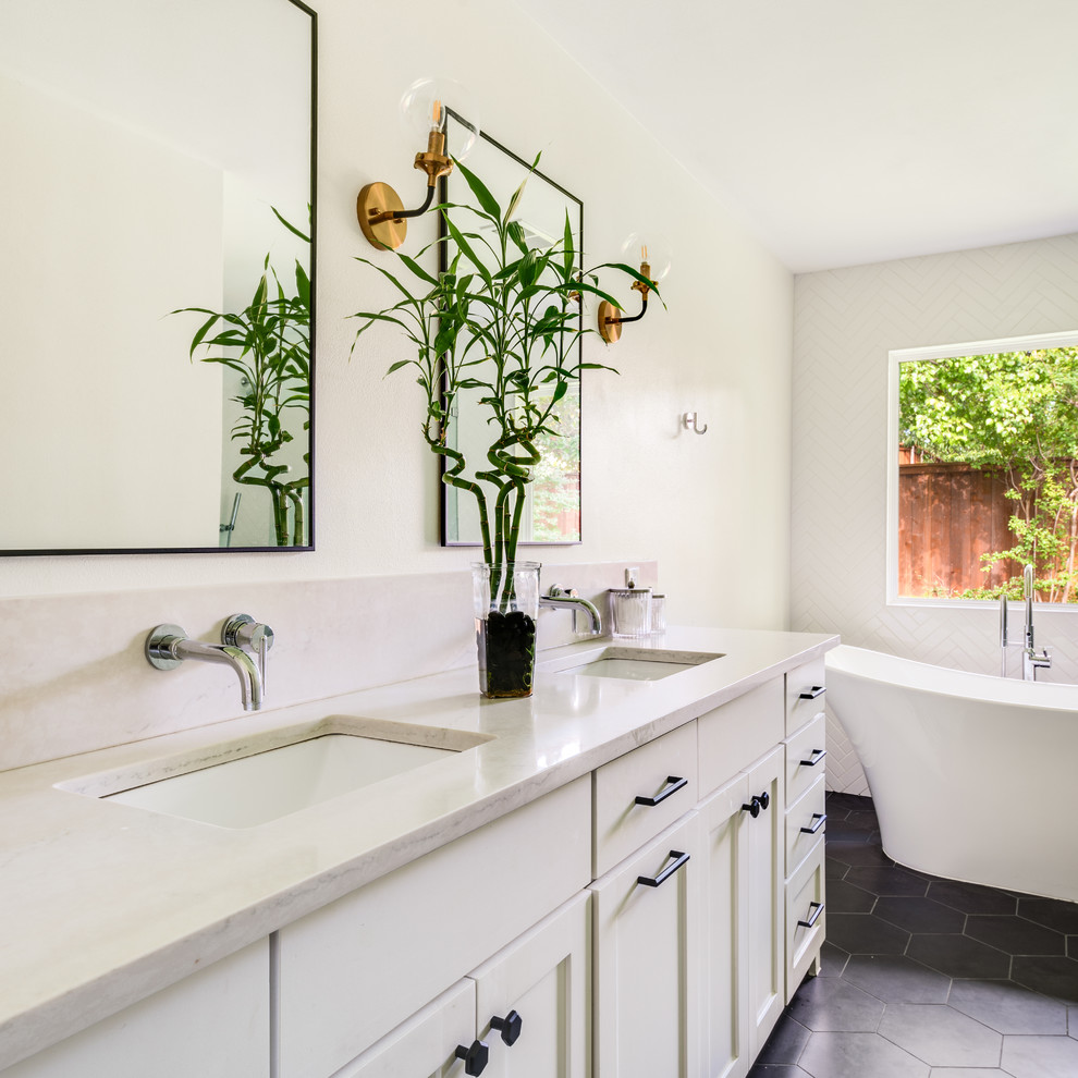 Photo of a medium sized classic ensuite bathroom in Dallas with shaker cabinets, white cabinets, a freestanding bath, white tiles, porcelain tiles, white walls, porcelain flooring, a submerged sink, engineered stone worktops, black floors and white worktops.