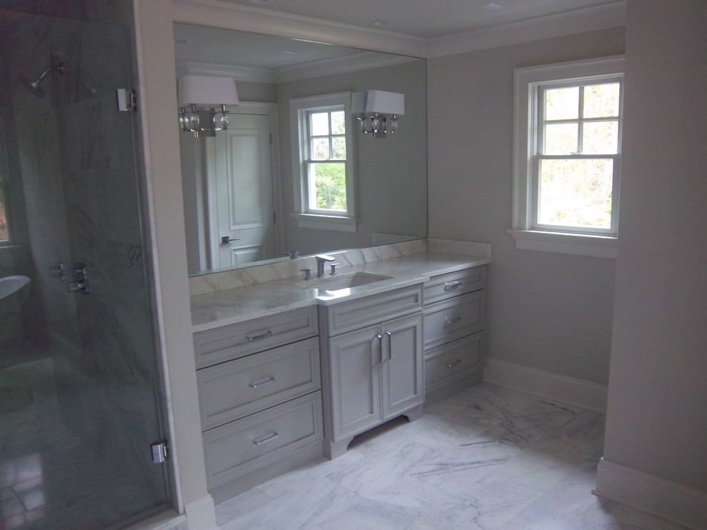 Bathroom - large traditional master white tile and marble tile marble floor and white floor bathroom idea in Other with recessed-panel cabinets, gray cabinets, a two-piece toilet, gray walls, a drop-in sink, marble countertops and a hinged shower door