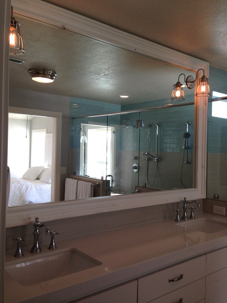 This is an example of a country bathroom in Salt Lake City with flat-panel cabinets and a double shower.