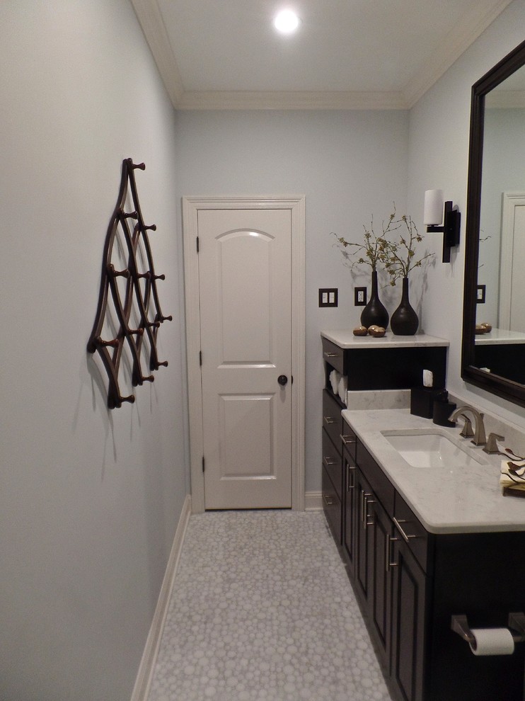 Alcove shower - mid-sized transitional kids' white tile and porcelain tile marble floor alcove shower idea in Other with raised-panel cabinets, dark wood cabinets, a two-piece toilet, gray walls, an undermount sink and quartz countertops