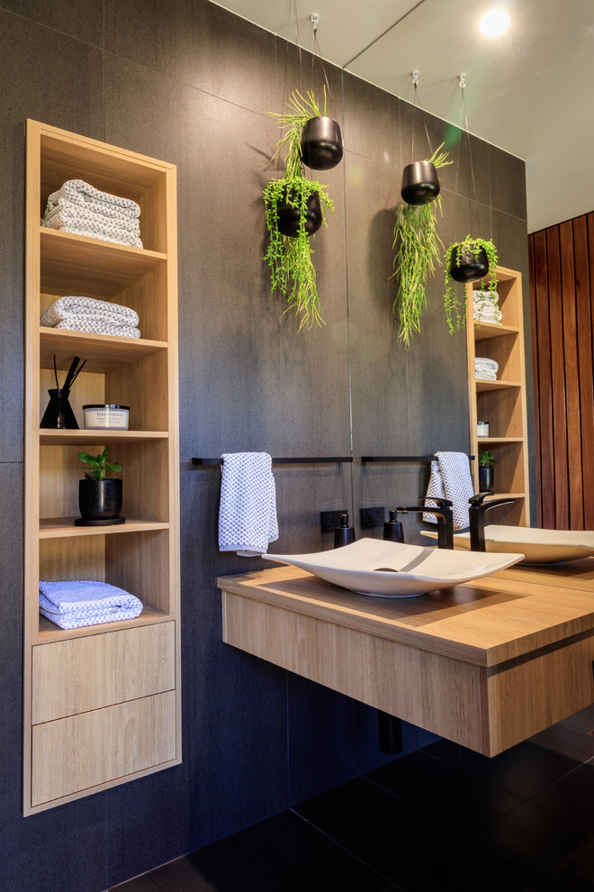 Inspiration for a contemporary black tile black floor bathroom remodel in Sunshine Coast with gray walls, a vessel sink, wood countertops and beige countertops