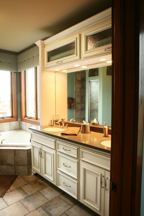 Inspiration pour une salle de bain principale traditionnelle avec des portes de placard blanches et une baignoire d'angle.
