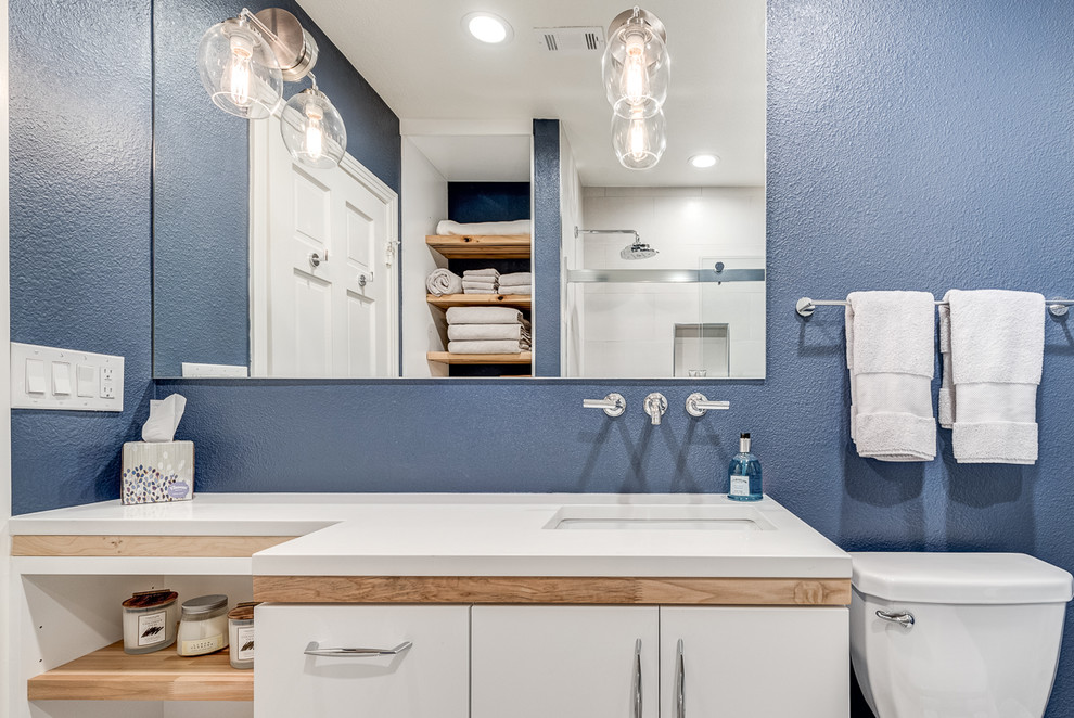 Photo of a traditional bathroom in Dallas with flat-panel cabinets, white cabinets, a shower/bath combination, white tiles, ceramic tiles, porcelain flooring, a submerged sink, beige floors and white worktops.
