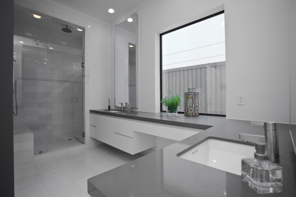 Alcove shower - contemporary white tile alcove shower idea in Dallas with an undermount sink, flat-panel cabinets, white cabinets and gray countertops