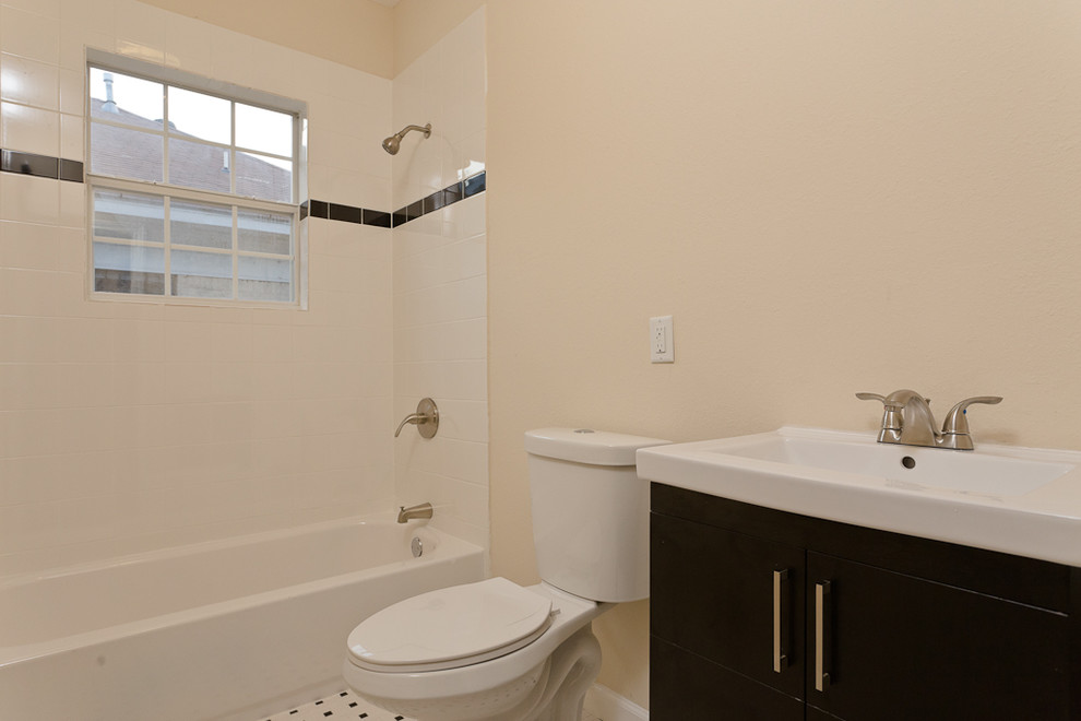 Mid-sized transitional white tile and ceramic tile ceramic tile bathroom photo in Houston with a console sink, furniture-like cabinets, dark wood cabinets, a two-piece toilet and yellow walls