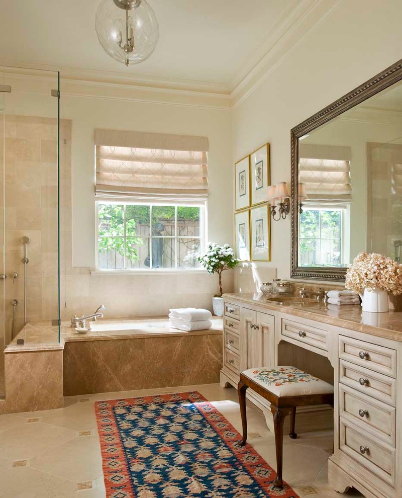 Aménagement d'une salle de bain classique avec un lavabo encastré, un placard avec porte à panneau encastré, des portes de placard beiges, une baignoire encastrée, une douche d'angle, un carrelage beige, un sol beige et un plan de toilette beige.