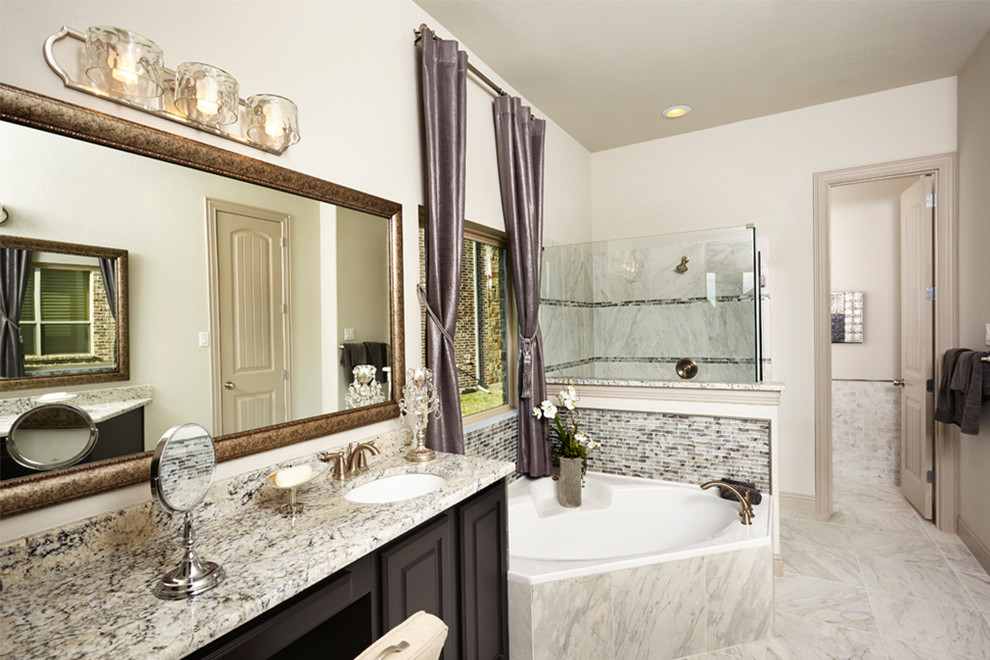 Example of a large transitional master gray tile and glass tile porcelain tile bathroom design in Dallas with raised-panel cabinets, black cabinets, white walls, an undermount sink and granite countertops