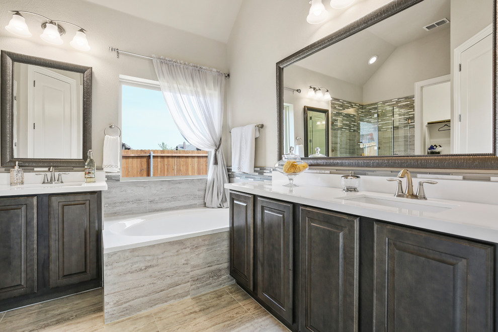 Bathroom - mid-sized contemporary master beige tile and ceramic tile ceramic tile and beige floor bathroom idea in Dallas with raised-panel cabinets, dark wood cabinets, beige walls, an undermount sink, solid surface countertops, a hinged shower door and white countertops