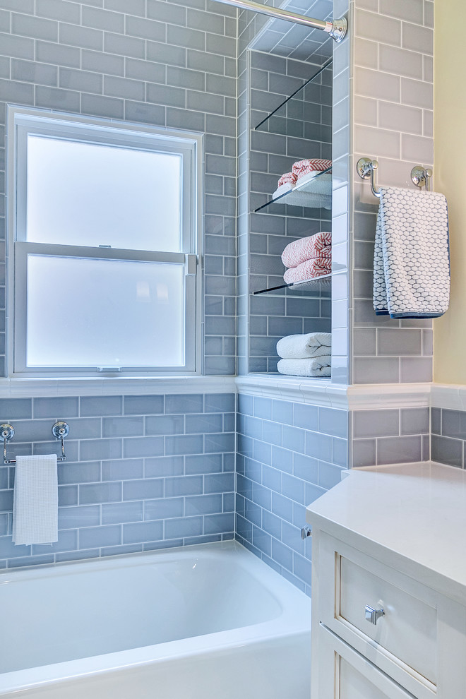 Photo of a small traditional shower room bathroom in Dallas with a submerged sink, recessed-panel cabinets, white cabinets, engineered stone worktops, an alcove bath, a shower/bath combination, a wall mounted toilet, grey tiles, ceramic tiles, ceramic flooring and yellow walls.