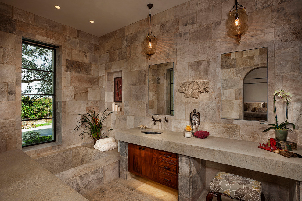 Photo of a mediterranean ensuite bathroom in Orange County with medium wood cabinets, beige tiles, beige walls, a submerged sink and beige floors.