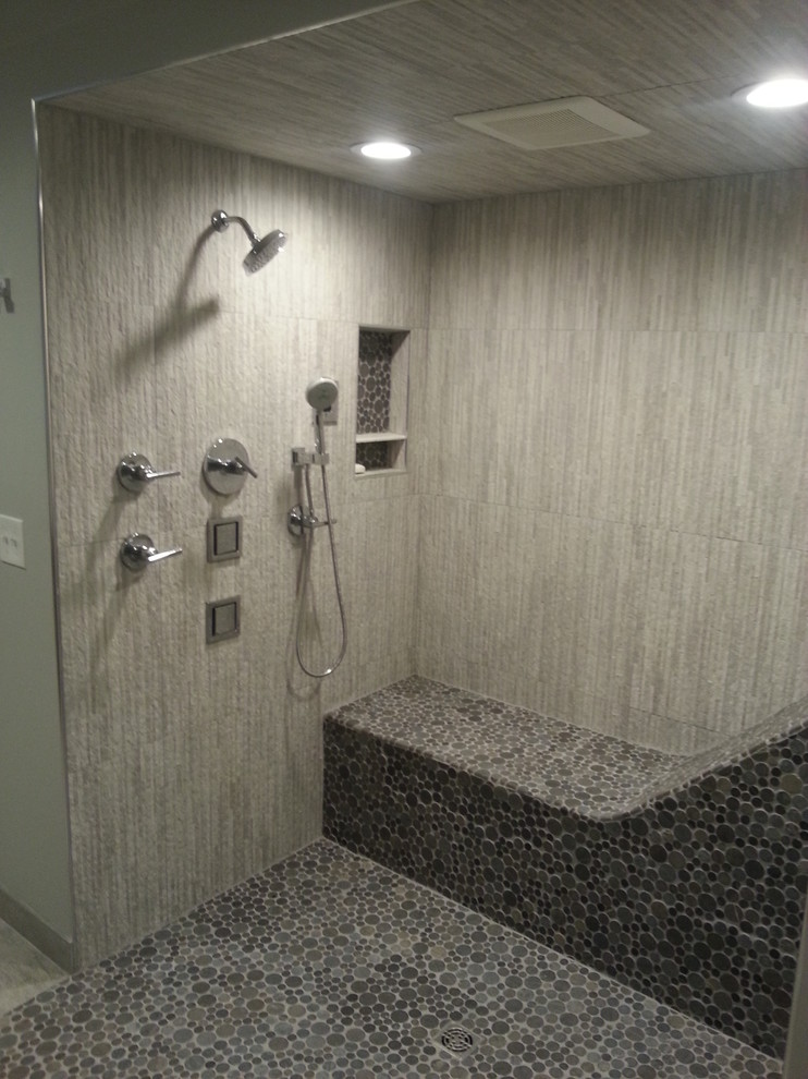 This is an example of a large contemporary ensuite bathroom in Atlanta with a submerged sink, flat-panel cabinets, medium wood cabinets, a freestanding bath, a built-in shower, grey tiles, porcelain tiles, grey walls and porcelain flooring.