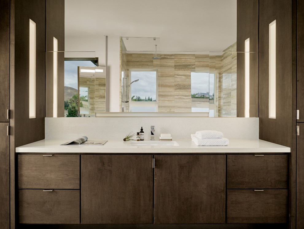 Large contemporary ensuite bathroom in San Francisco with flat-panel cabinets, dark wood cabinets, a built-in bath, a built-in shower, beige tiles, stone tiles, white walls, travertine flooring, a submerged sink and engineered stone worktops.