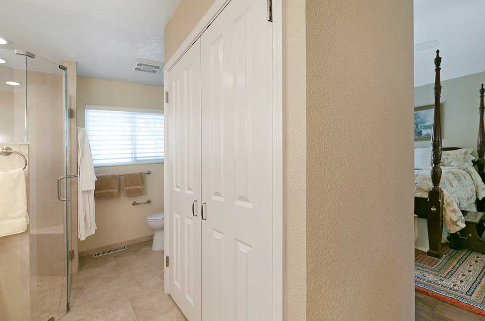 Idéer för att renovera ett stort vintage beige beige en-suite badrum, med luckor med infälld panel, vita skåp, en dusch i en alkov, en toalettstol med separat cisternkåpa, beige kakel, porslinskakel, beige väggar, klinkergolv i porslin, ett undermonterad handfat, bänkskiva i kvarts, beiget golv och dusch med gångjärnsdörr