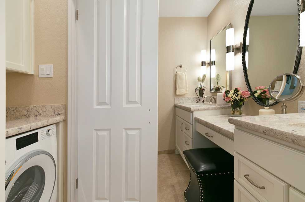 Design ideas for a large traditional ensuite bathroom in San Francisco with recessed-panel cabinets, white cabinets, an alcove shower, a two-piece toilet, beige tiles, porcelain tiles, beige walls, porcelain flooring, a submerged sink, engineered stone worktops, beige floors, a hinged door, beige worktops, a laundry area, double sinks and a built in vanity unit.