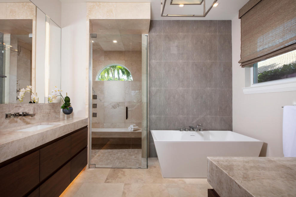 Inspiration for a large coastal master beige tile and porcelain tile travertine floor, beige floor and single-sink bathroom remodel in Miami with flat-panel cabinets, dark wood cabinets, a one-piece toilet, beige walls, a vessel sink, quartzite countertops, a hinged shower door, beige countertops and a built-in vanity