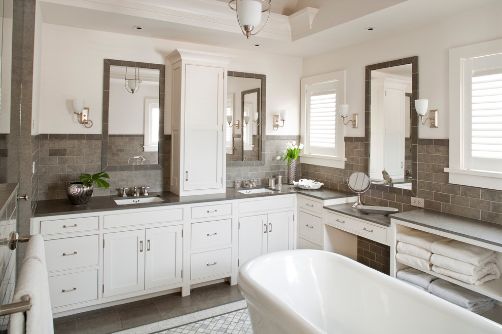 Example of a beach style master subway tile and gray tile ceramic tile freestanding bathtub design in Bridgeport with an undermount sink, white cabinets, recessed-panel cabinets and white walls