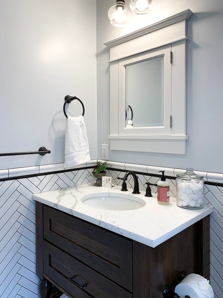 Inspiration for a small modern 3/4 black and white tile and subway tile mosaic tile floor and multicolored floor bathroom remodel in Philadelphia with recessed-panel cabinets, dark wood cabinets, a two-piece toilet, blue walls, an undermount sink, marble countertops, multicolored countertops and a hinged shower door