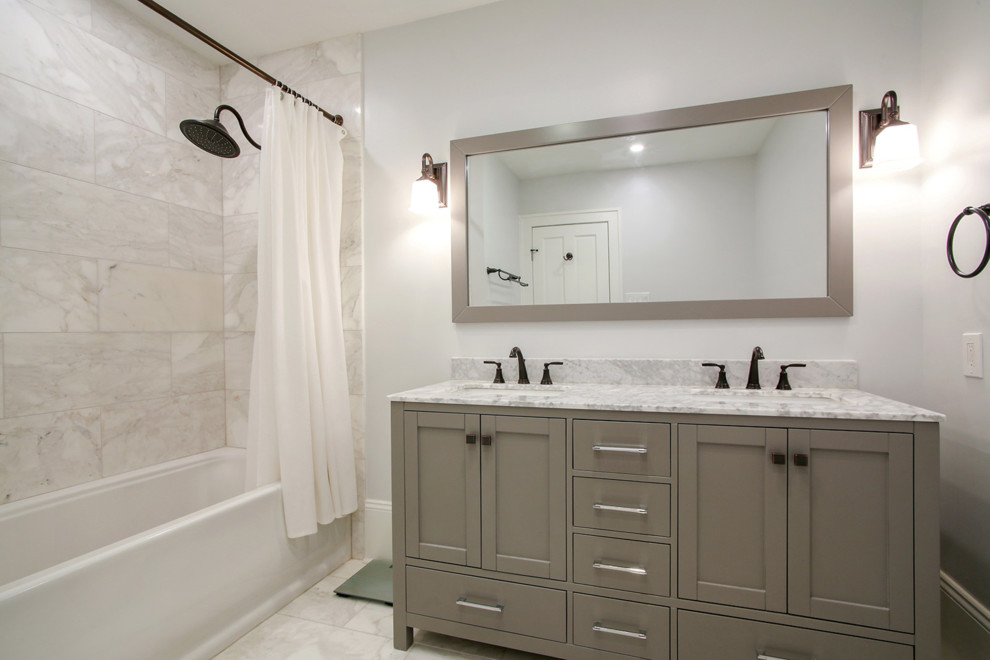 This is an example of a small traditional ensuite bathroom in New Orleans with shaker cabinets, grey cabinets, an alcove bath, a shower/bath combination, white tiles, metal tiles, white walls, marble flooring, a submerged sink, marble worktops, white floors, a shower curtain and white worktops.