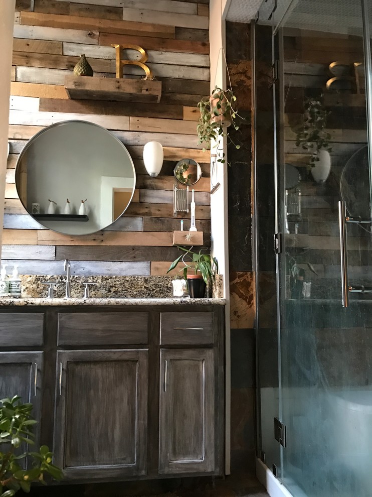 Inspiration for a mid-sized rustic master multicolored tile and mirror tile slate floor and multicolored floor bathroom remodel in New Orleans with recessed-panel cabinets, distressed cabinets, a one-piece toilet, gray walls, an undermount sink, granite countertops and a hinged shower door