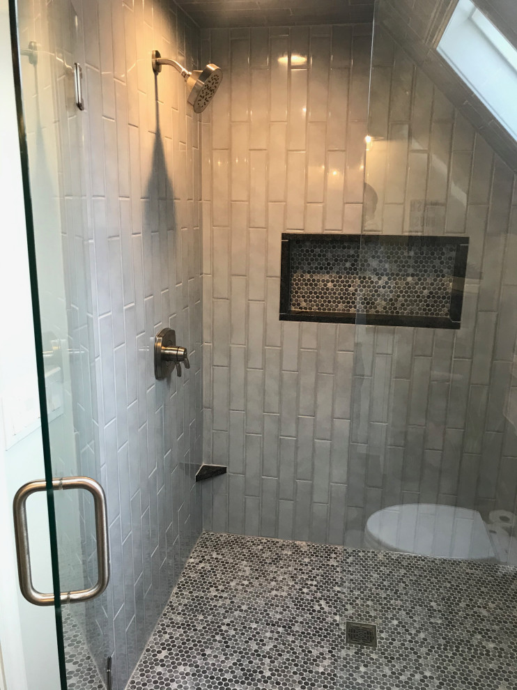 Mid-sized elegant master blue tile and ceramic tile ceramic tile, gray floor and single-sink alcove shower photo in Detroit with shaker cabinets, white cabinets, a two-piece toilet, blue walls, an undermount sink, granite countertops, a hinged shower door, black countertops and a freestanding vanity