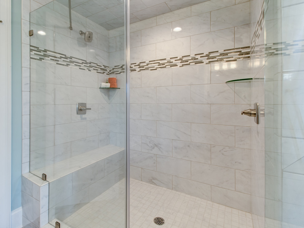 This is an example of a large traditional ensuite bathroom in Other with raised-panel cabinets, brown cabinets, a built-in bath, a double shower, a one-piece toilet, white tiles, ceramic tiles, blue walls, porcelain flooring, a submerged sink, granite worktops, grey floors and a hinged door.