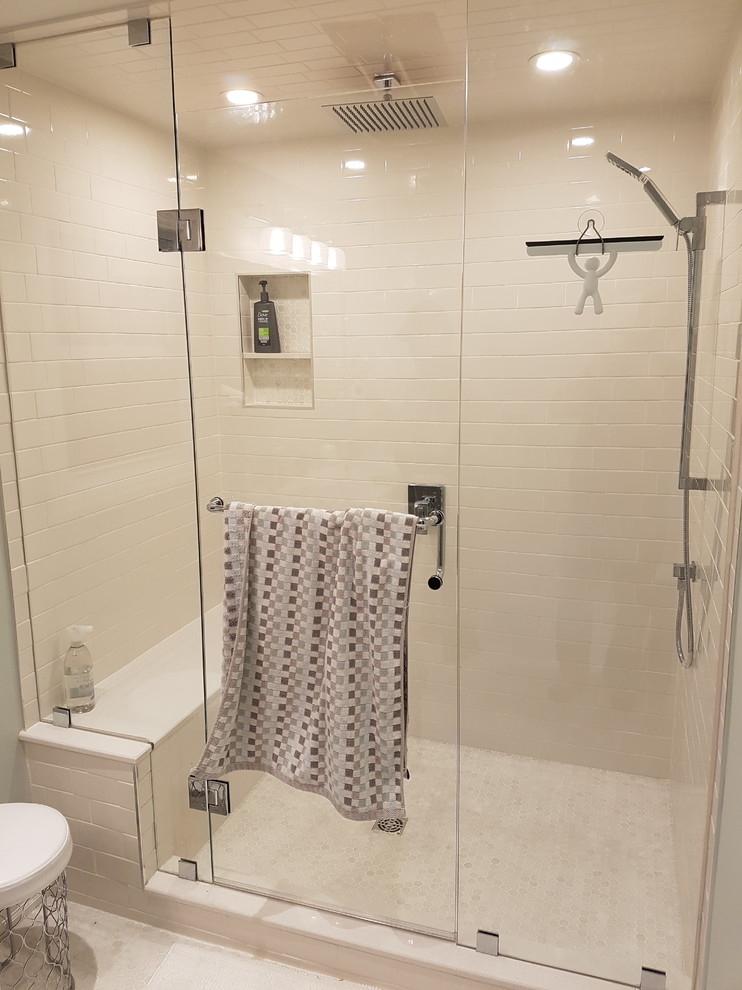 Alcove shower - mid-sized transitional master white tile and ceramic tile mosaic tile floor and white floor alcove shower idea in Toronto with shaker cabinets, distressed cabinets, a one-piece toilet, gray walls, an undermount sink, quartz countertops and a hinged shower door