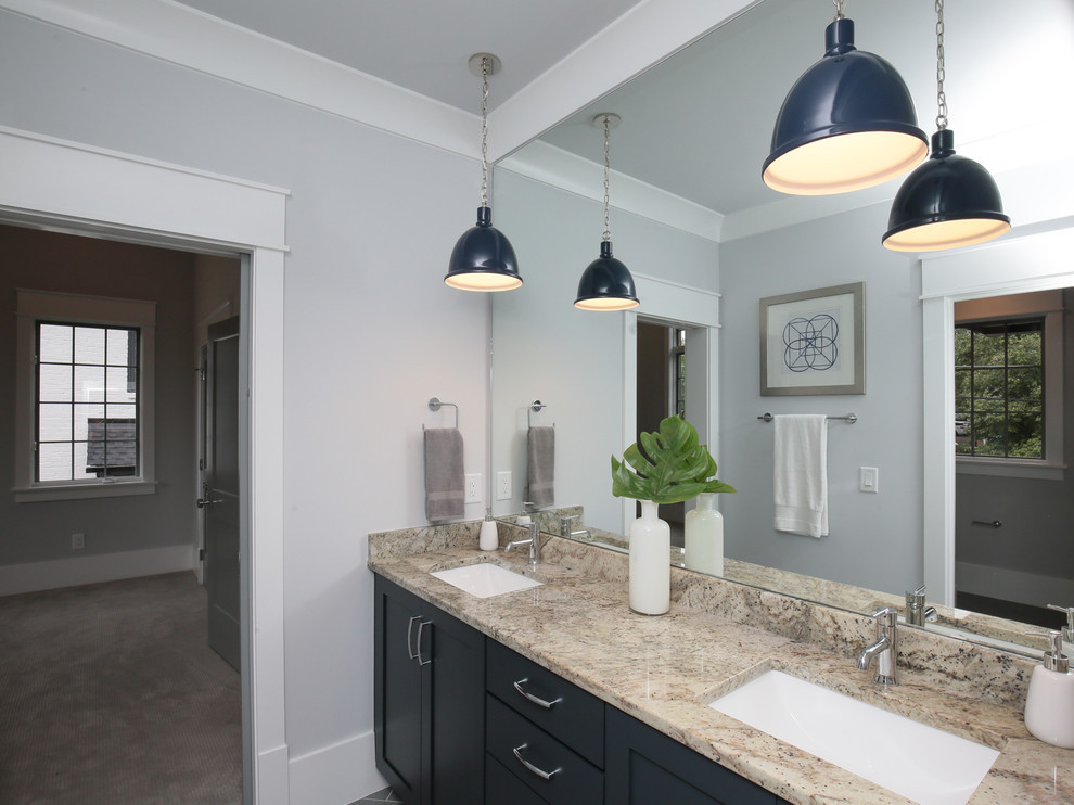 Photo of a large traditional family bathroom in Raleigh with shaker cabinets, blue cabinets, grey walls, porcelain flooring, granite worktops, grey floors and multi-coloured worktops.