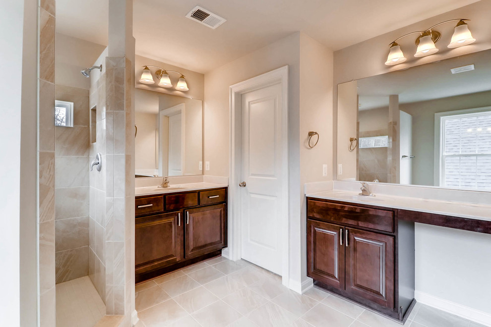 Large elegant beige tile and ceramic tile ceramic tile and beige floor bathroom photo in Baltimore with raised-panel cabinets, dark wood cabinets, beige walls and an integrated sink