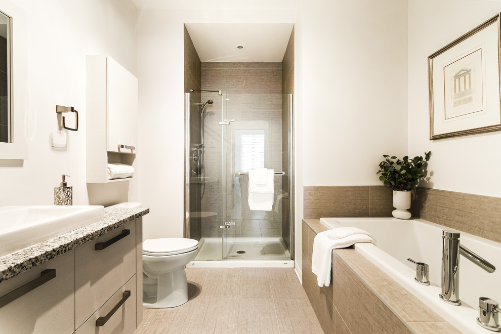 Inspiration for a medium sized urban ensuite bathroom in Montreal with flat-panel cabinets, beige cabinets, an alcove bath, an alcove shower, a two-piece toilet, beige tiles, porcelain tiles, white walls, porcelain flooring, a built-in sink, granite worktops, beige floors, a hinged door and multi-coloured worktops.