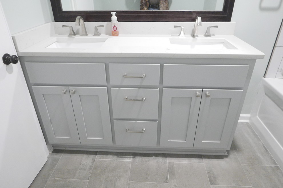 Example of a mid-sized transitional kids' white tile and porcelain tile porcelain tile and gray floor bathroom design in Other with shaker cabinets, gray cabinets, a two-piece toilet, green walls, an undermount sink, quartz countertops and white countertops