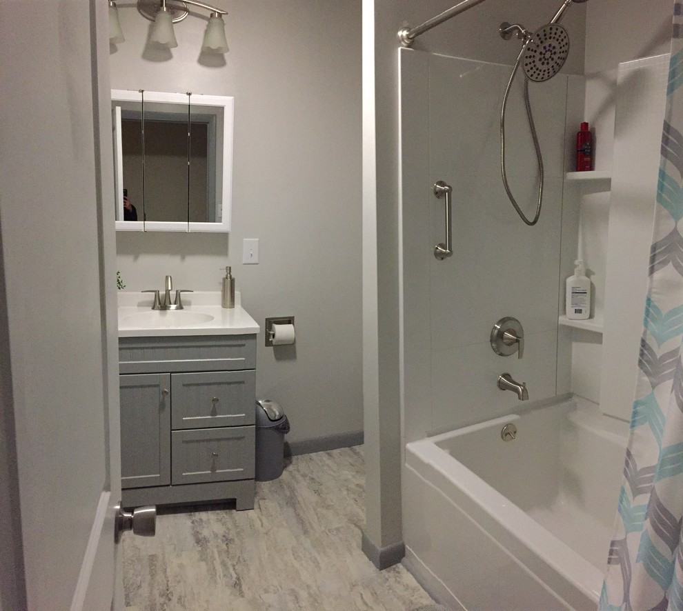 Mid-sized minimalist vinyl floor and gray floor bathroom photo in Other with beaded inset cabinets, gray cabinets, gray walls and an integrated sink