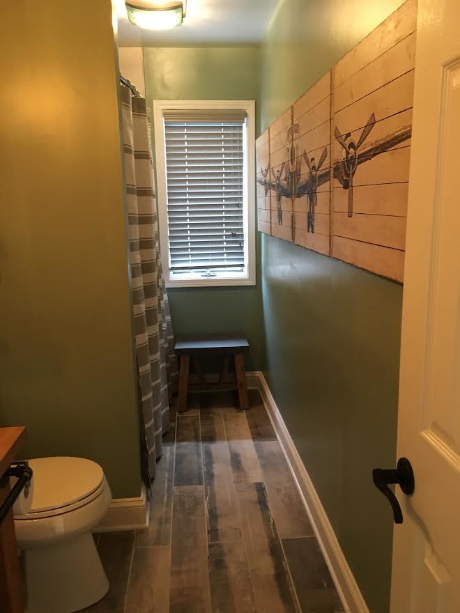 Bathroom - small craftsman 3/4 dark wood floor and brown floor bathroom idea in New York with green walls