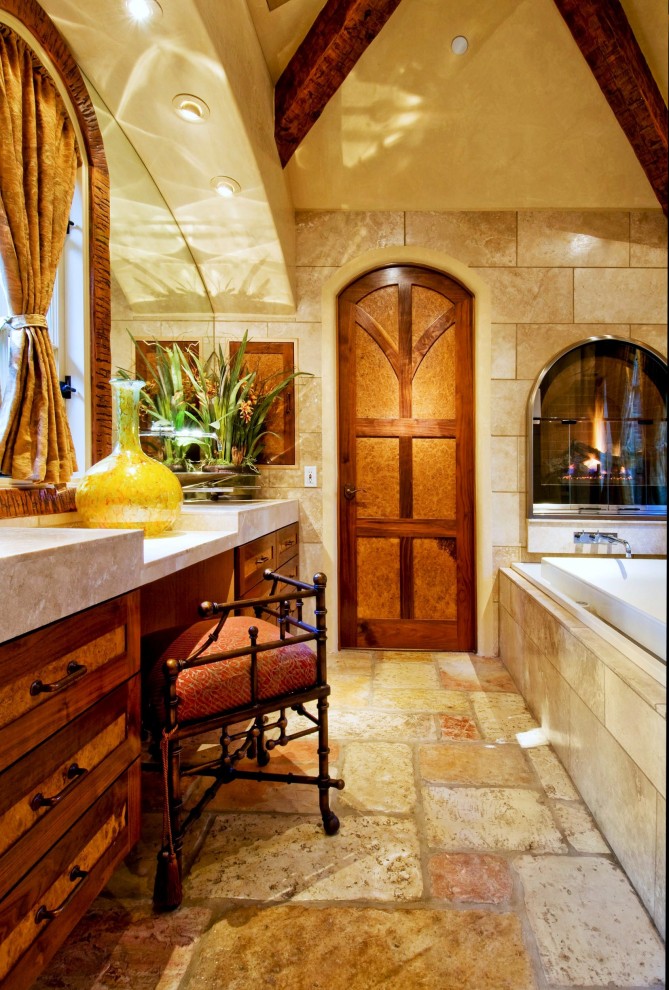 Exemple d'une salle de bain principale chic en bois brun de taille moyenne avec une baignoire posée, un placard à porte shaker, un sol en travertin et un plan de toilette en marbre.