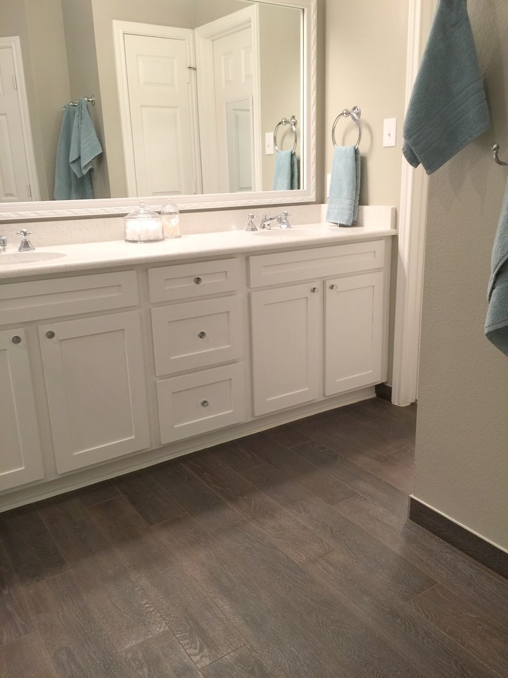 This is an example of a medium sized beach style ensuite bathroom in Dallas with a submerged sink, shaker cabinets, white cabinets, engineered stone worktops, a built-in bath, a corner shower, grey tiles, porcelain tiles, grey walls and porcelain flooring.